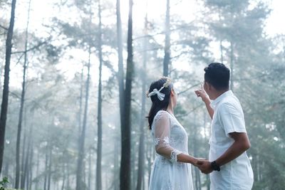 Couple standing in forest