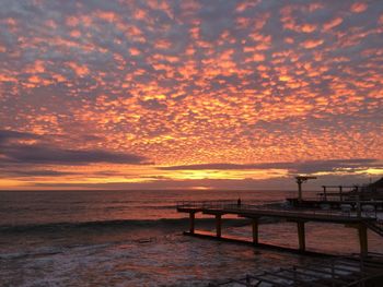Scenic view of sea against orange sky
