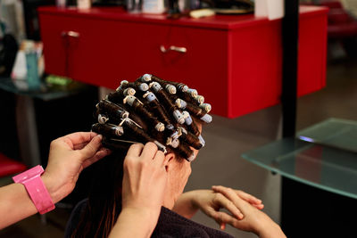 Close up shot of a hairdresser doing her client's curls