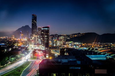 High angle view of illuminated buildings in city at night