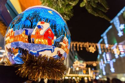 Low angle view of illuminated carousel at night