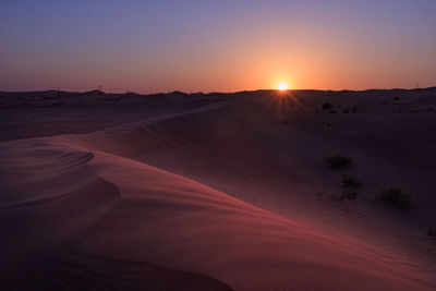 Scenic view of desert against sky during sunrise