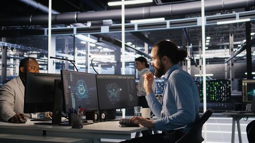 Rear view of woman using digital tablet in cafe