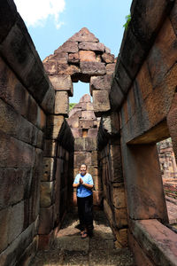 Woman standing at historical building