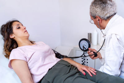 Female doctor examining patient in hospital