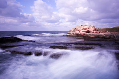 Scenic view of sea against cloudy sky