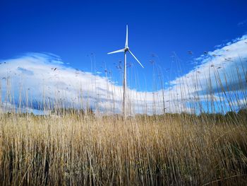 Windmill on field against sky