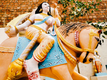 Low angle view of statue against wall