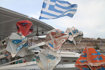 Low angle view of flags on abandoned building against sky