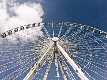 Low angle view of ferris wheel against blue sky