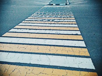 Close-up of zebra crossing on road