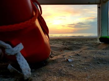 Close-up of rope at beach during sunset