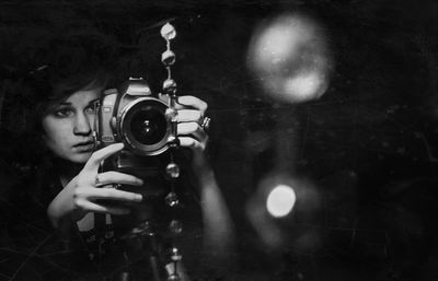 Portrait of young man holding camera