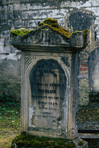 Text on stone wall at cemetery