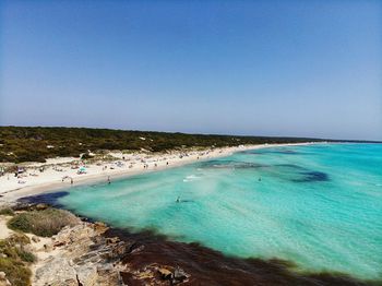 Scenic view of beach against clear blue sky