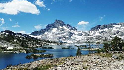 Scenic view of river and mountains against sky