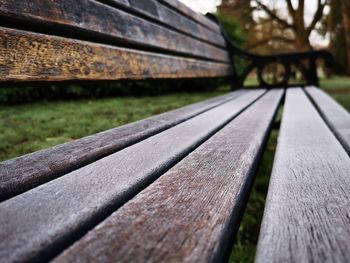 Close-up of bench on footpath
