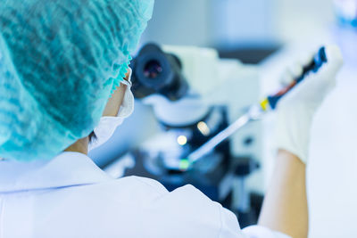 Rear view of woman working in laboratory