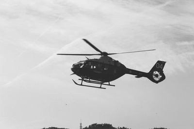 Low angle view of airplane flying against sky