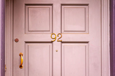 House number 92 on a wooden front door in london 