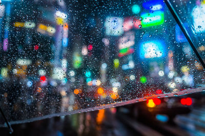 Road seen through wet umbrella during rainy season