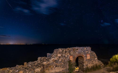 Castle against sky at night