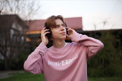 Man looking away while listening music