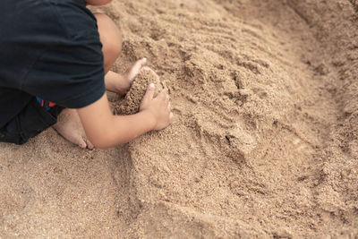 Low section of child on sand