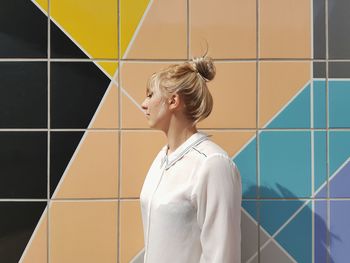 Woman standing against wall