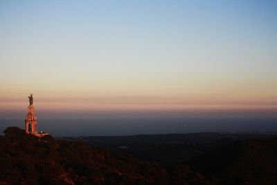 Scenic view of buildings against sky during sunset