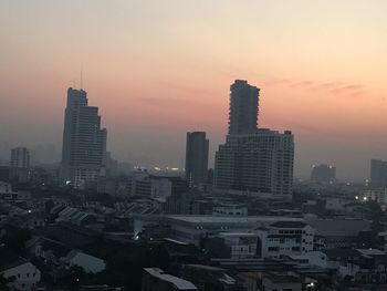 High angle view of modern buildings against sky during sunset