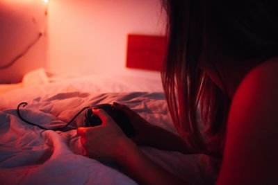 Close-up of woman relaxing on bed at home