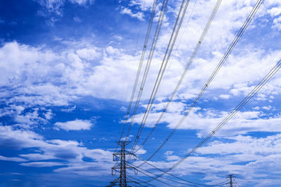 Low angle view of electricity pylon against sky