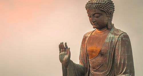 Low angle view of statue against temple