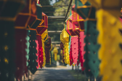 Close-up of multi colored lanterns hanging in row at temple