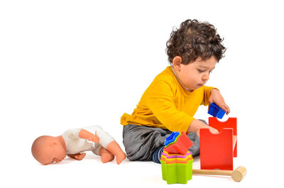 Boy looking away over white background