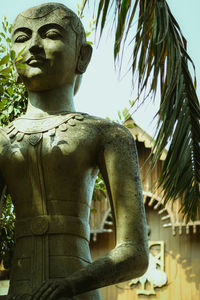 Low angle view of statue against trees