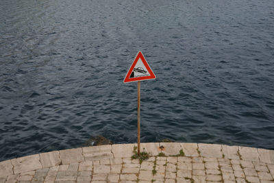 Road sign by sea