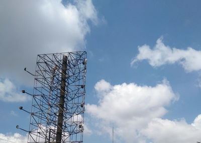 Low angle view of telephone pole against sky