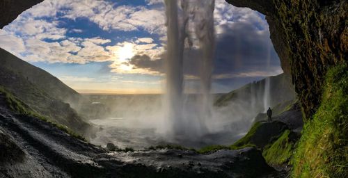 Scenic view of waterfall against sky