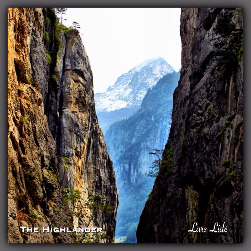 transfer print, mountain, auto post production filter, mountain range, scenics, tranquil scene, rock formation, beauty in nature, tranquility, rock - object, nature, rocky mountains, cliff, sky, water, rock, day, idyllic, clear sky, non-urban scene