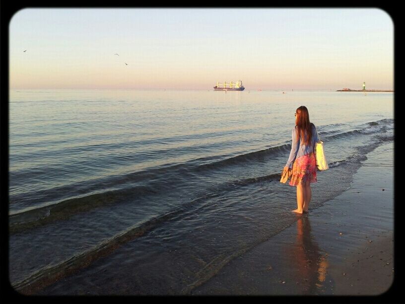 sea, water, horizon over water, full length, beach, lifestyles, leisure activity, transfer print, rear view, shore, standing, auto post production filter, tranquil scene, casual clothing, beauty in nature, scenics, tranquility, vacations