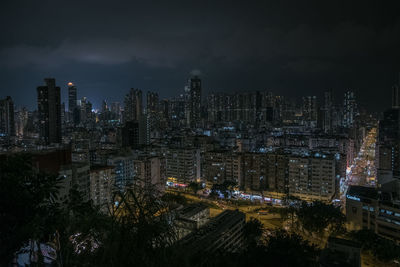 High angle view of illuminated buildings against sky at night