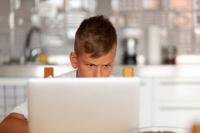 Portrait of boy using mobile phone