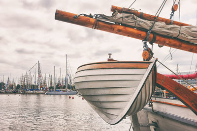 Sailboat moored on ship against sky