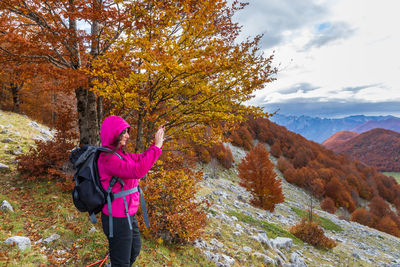 Rear view of woman standing on mountain