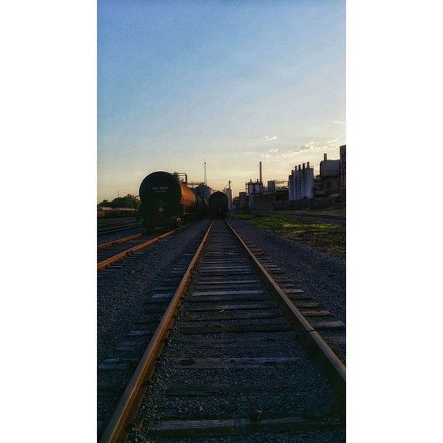 railroad track, rail transportation, transportation, the way forward, diminishing perspective, vanishing point, sky, public transportation, built structure, architecture, railway track, transfer print, auto post production filter, clear sky, railroad station, railroad station platform, no people, long, day, outdoors