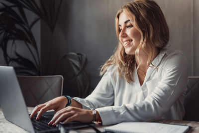 Young woman using laptop at home