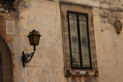 Low angle view of street light against building