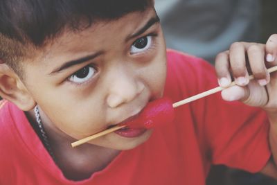 Close-up portrait of boy eating food